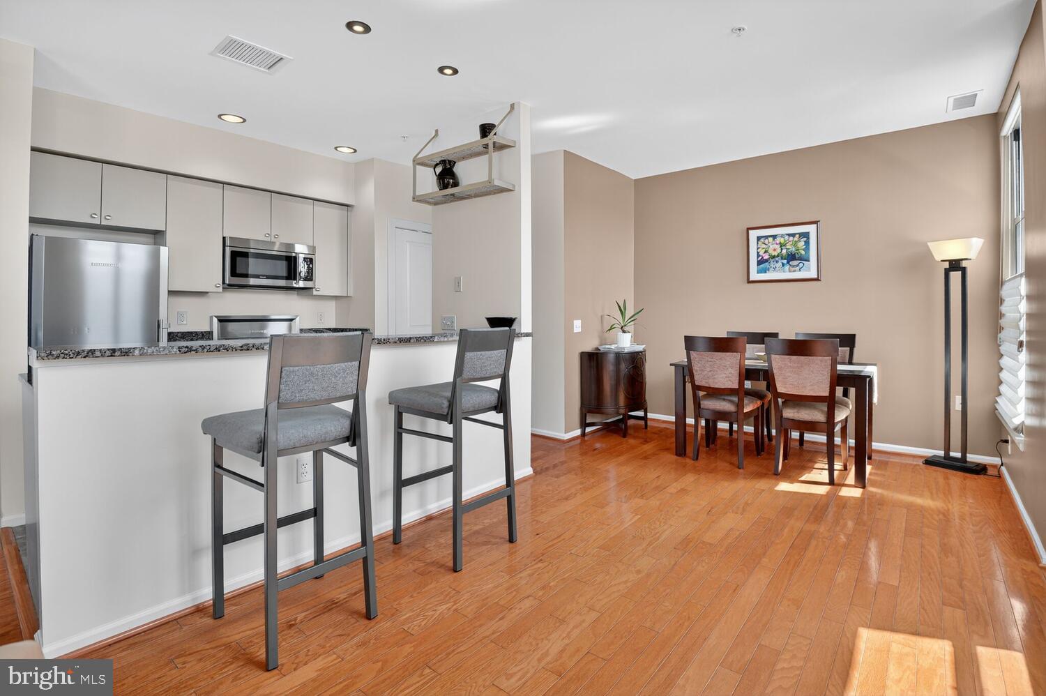 343 Cedar Street Northwest, Unit 322 Washington, DC 20012 - Photo 8 of 40 a living room with stainless steel appliances kitchen island granite countertop furniture and a dining table