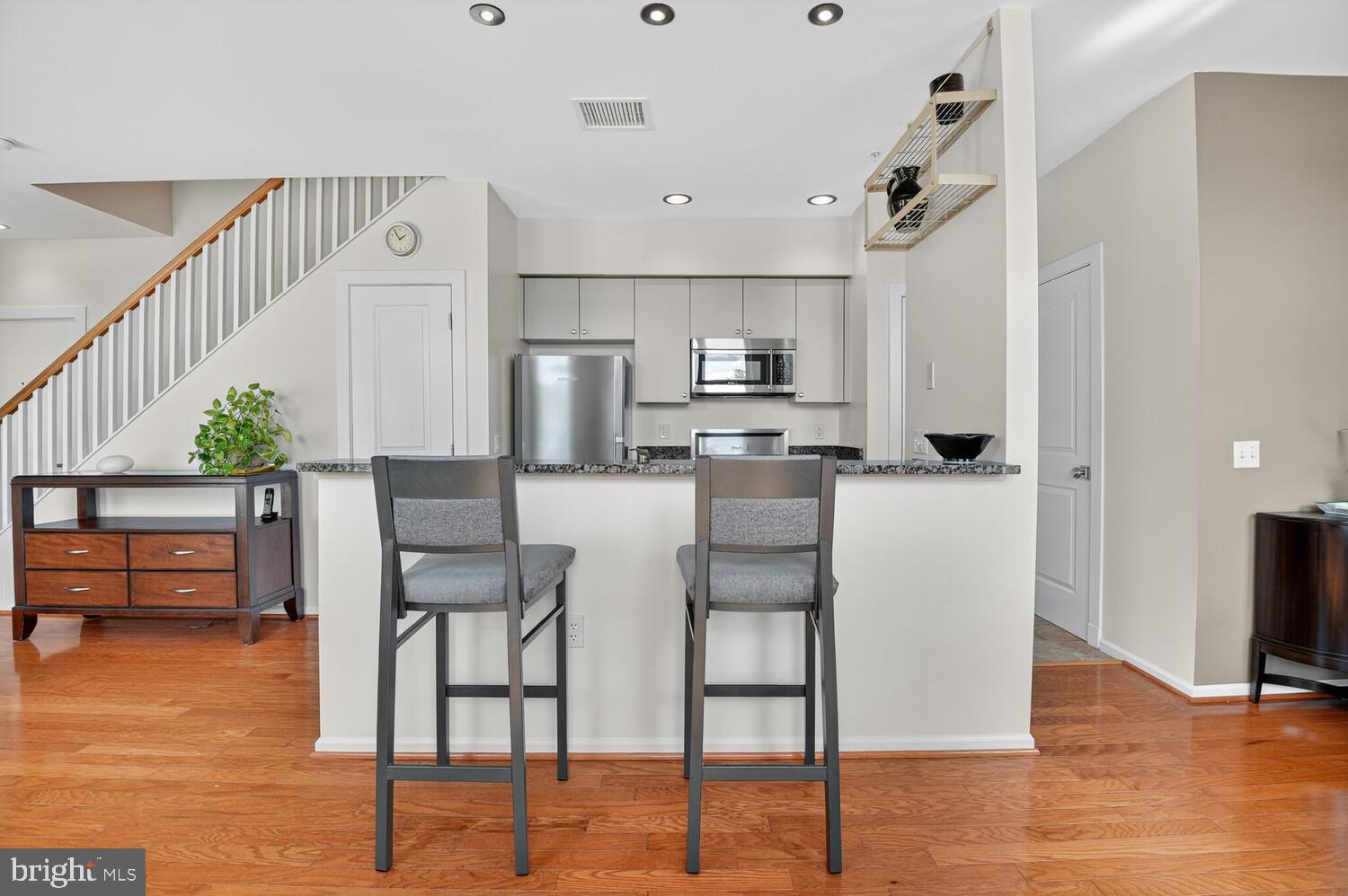343 Cedar Street Northwest, Unit 322 Washington, DC 20012 - Photo 9 of 40 a kitchen with stainless steel appliances kitchen island granite countertop a refrigerator and a stove top oven