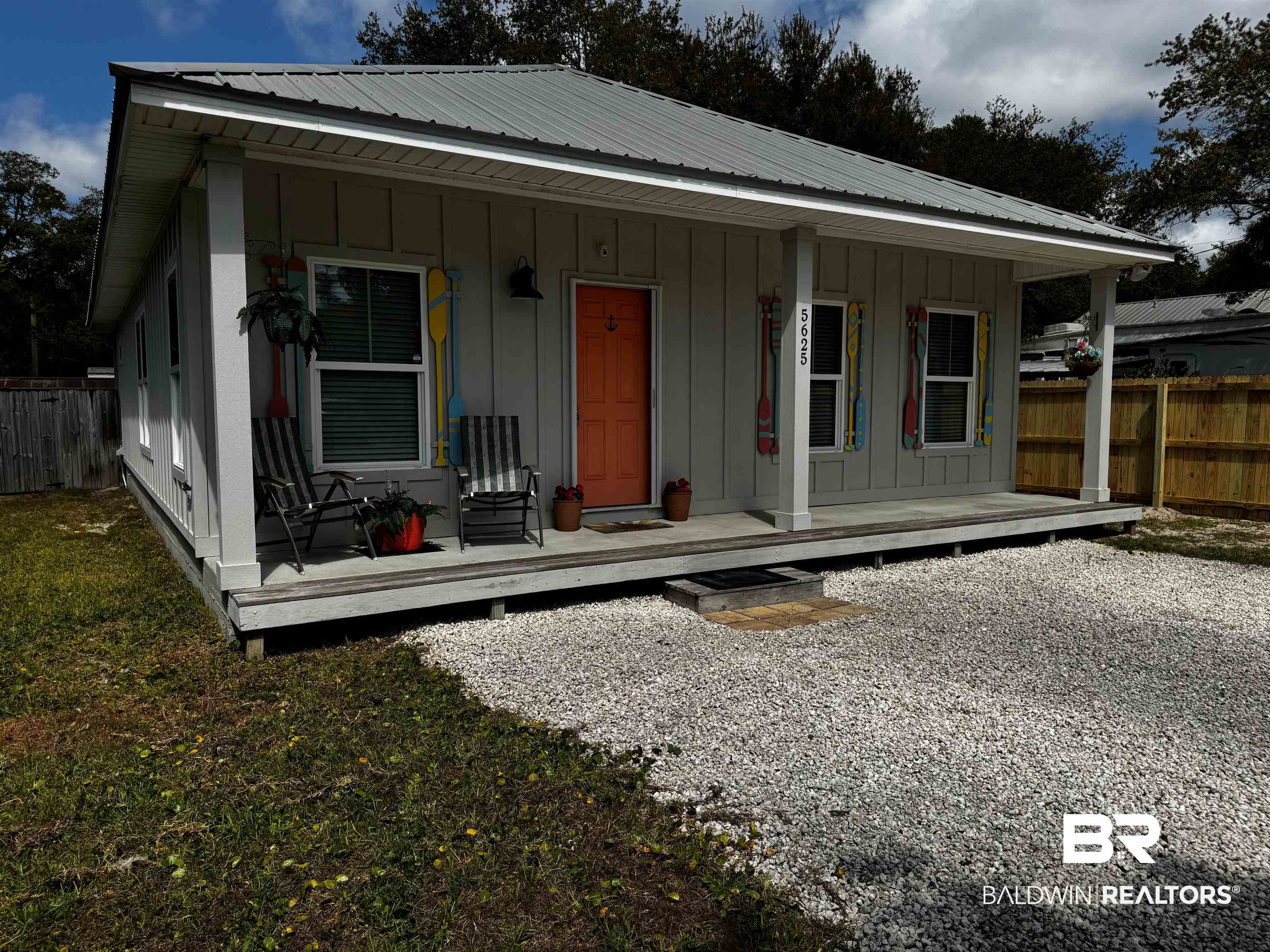 5625 Georgia Street Orange Beach, AL 36561 - Photo 3 of 30 Bungalow with board and batten siding, fence, covered porch, and metal roof