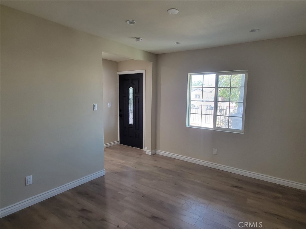 140 North 4th Street Colton, CA 92324 - Photo 11 of 22 an empty room with wooden floor and windows