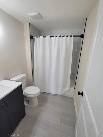 a bathroom with a toilet and shower
