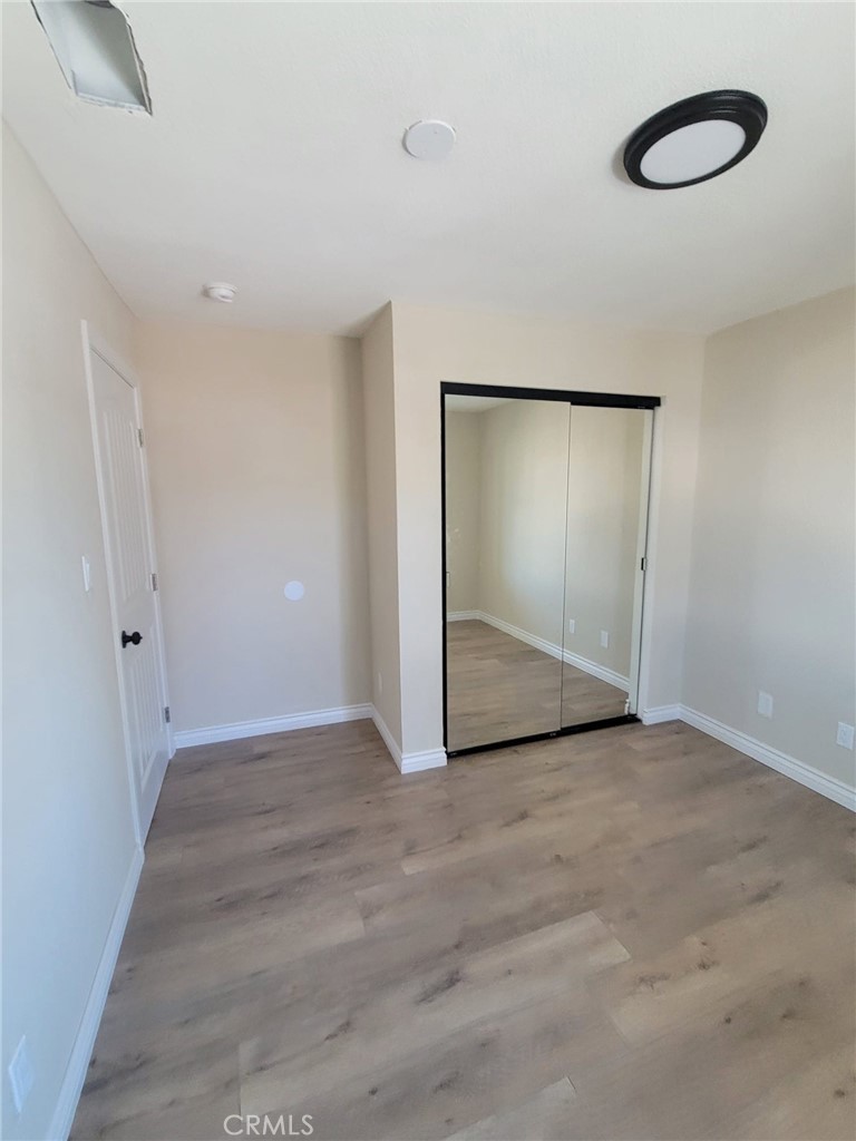 140 North 4th Street Colton, CA 92324 - Photo 15 of 22 a view of an empty room with wooden floor and closet