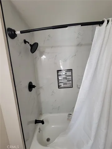a bathroom with a bathtub and a shower