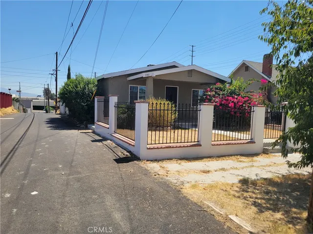 a view of a house with a small yard and plants