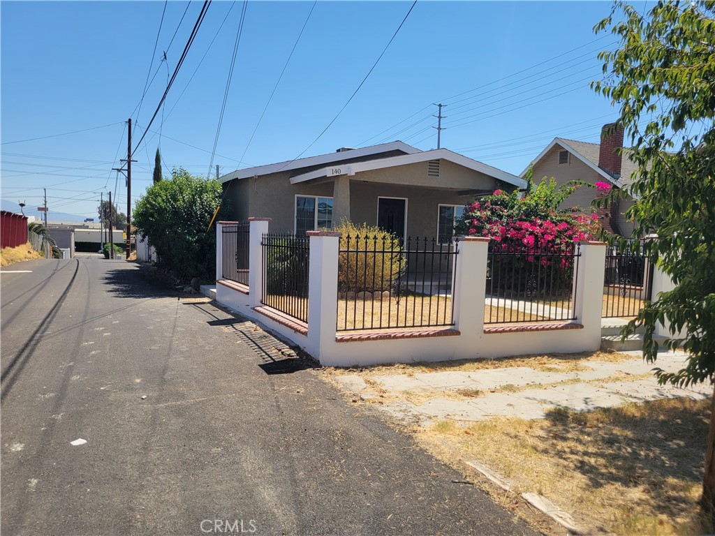 140 North 4th Street Colton, CA 92324 - Photo 4 of 22 a view of a house with a small yard and plants