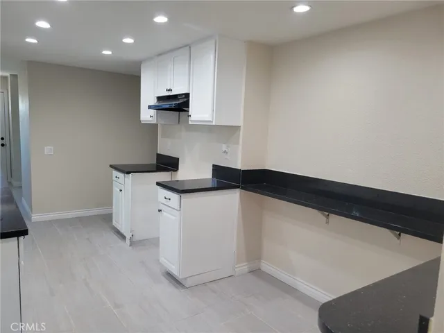 a kitchen with a sink dishwasher and a refrigerator