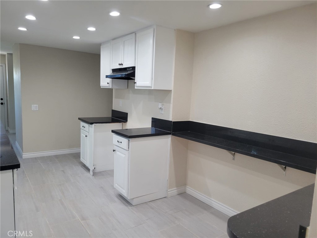 140 North 4th Street Colton, CA 92324 - Photo 7 of 22 a kitchen with a sink dishwasher and a refrigerator