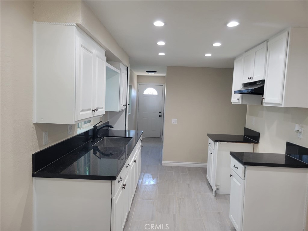 140 North 4th Street Colton, CA 92324 - Photo 8 of 22 a kitchen with granite countertop a sink and white cabinets