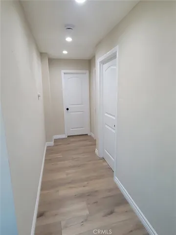 a view of a hallway with wooden floor