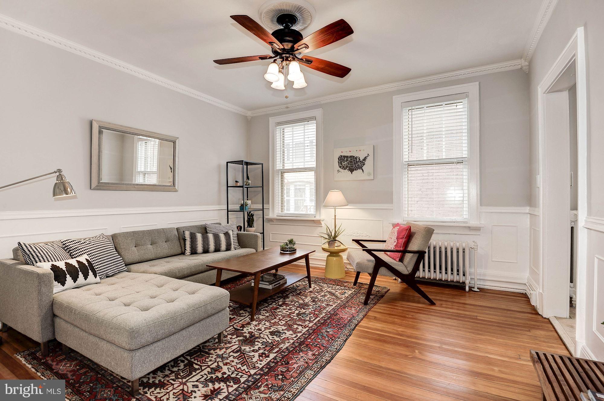 516 A Street Northeast, Unit 205 Washington, DC 20002 - Photo 1 of 21 a living room with furniture ceiling fan and a rug