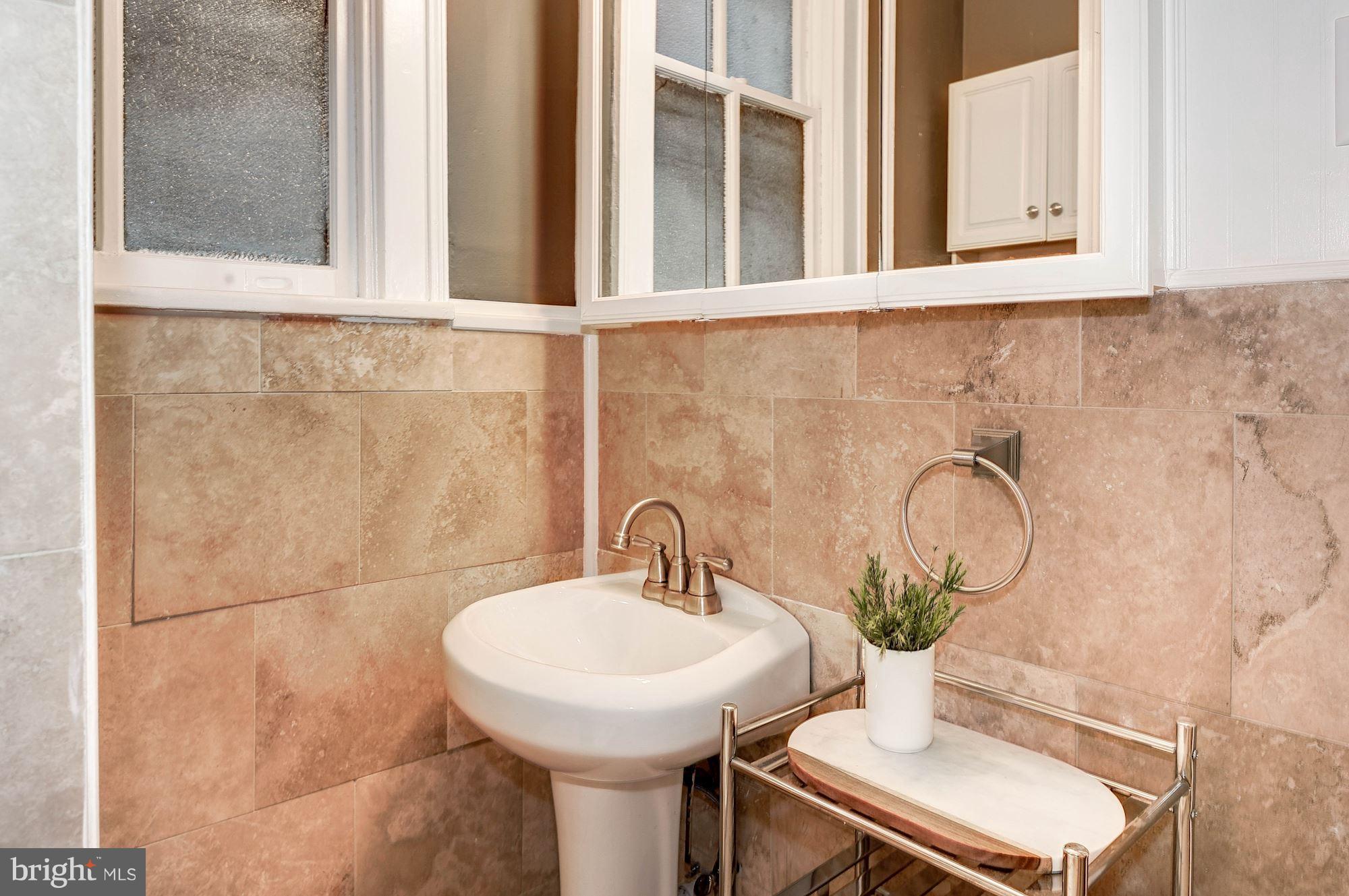 516 A Street Northeast, Unit 205 Washington, DC 20002 - Photo 17 of 21 a bathroom with a sink and a mirror