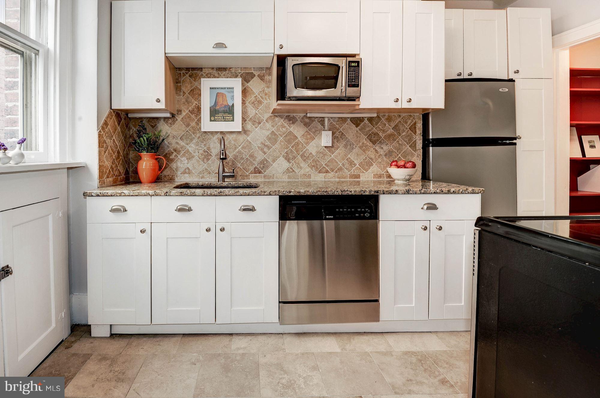 516 A Street Northeast, Unit 205 Washington, DC 20002 - Photo 9 of 21 a kitchen with stainless steel appliances granite countertop a refrigerator stove and sink