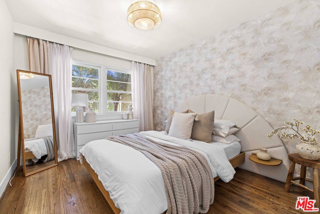 1325 Washington Avenue, Unit C Santa Monica, CA 90403 - Photo 8 of 23 a bedroom with a bed and wooden floor