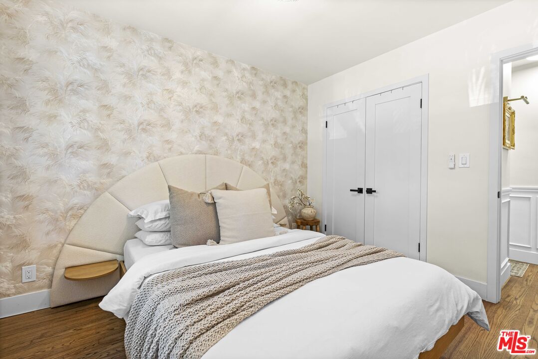 1325 Washington Avenue, Unit C Santa Monica, CA 90403 - Photo 9 of 23 a bedroom with a bed and a wooden floor