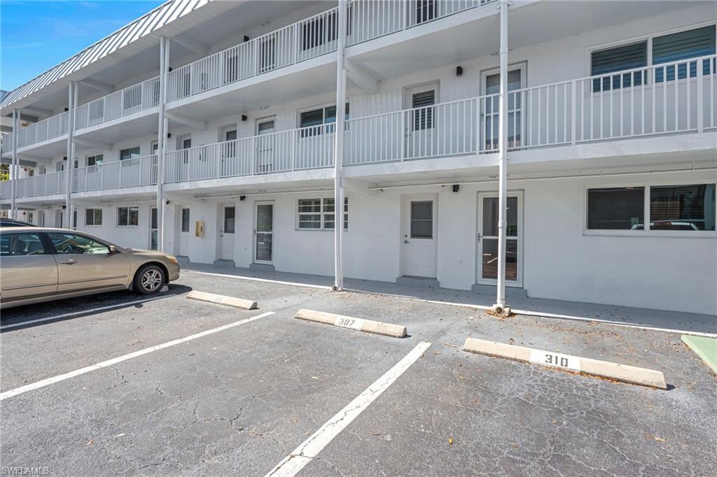 72 7th Street South, Unit 108 Naples, FL 34102 - Photo 11 of 22 a view of a car park in front of a building