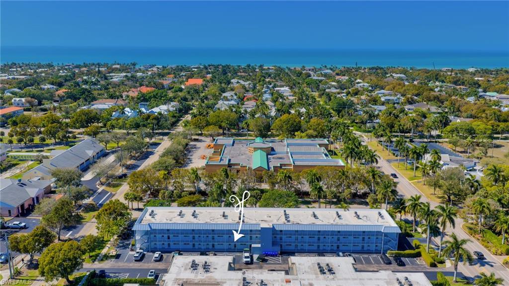 72 7th Street South, Unit 108 Naples, FL 34102 - Photo 20 of 22 an aerial view of a house with a lake view