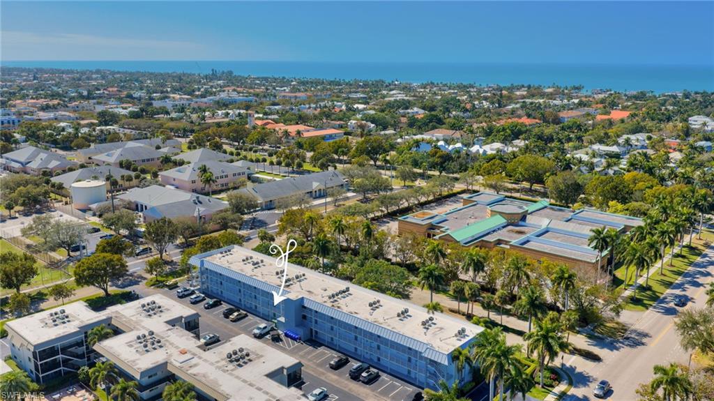 72 7th Street South, Unit 108 Naples, FL 34102 - Photo 21 of 22 an aerial view of residential house with parking space