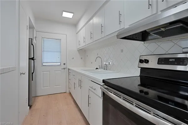 a kitchen with a sink and cabinets