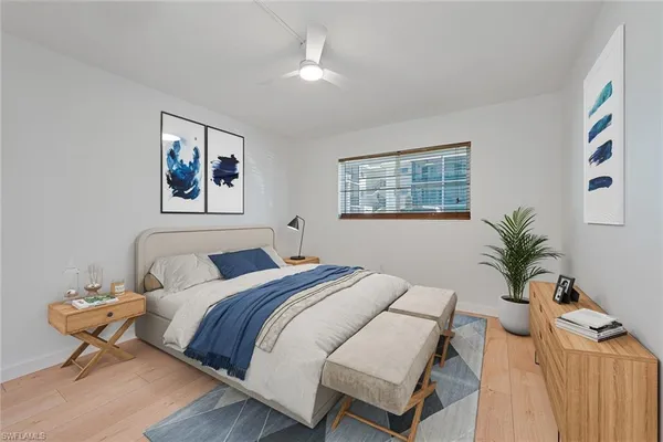 a bedroom with a bed and a painting on the wall