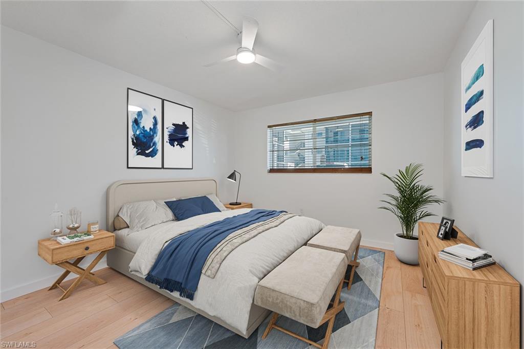 72 7th Street South, Unit 108 Naples, FL 34102 - Photo 4 of 22 a bedroom with a bed and a painting on the wall