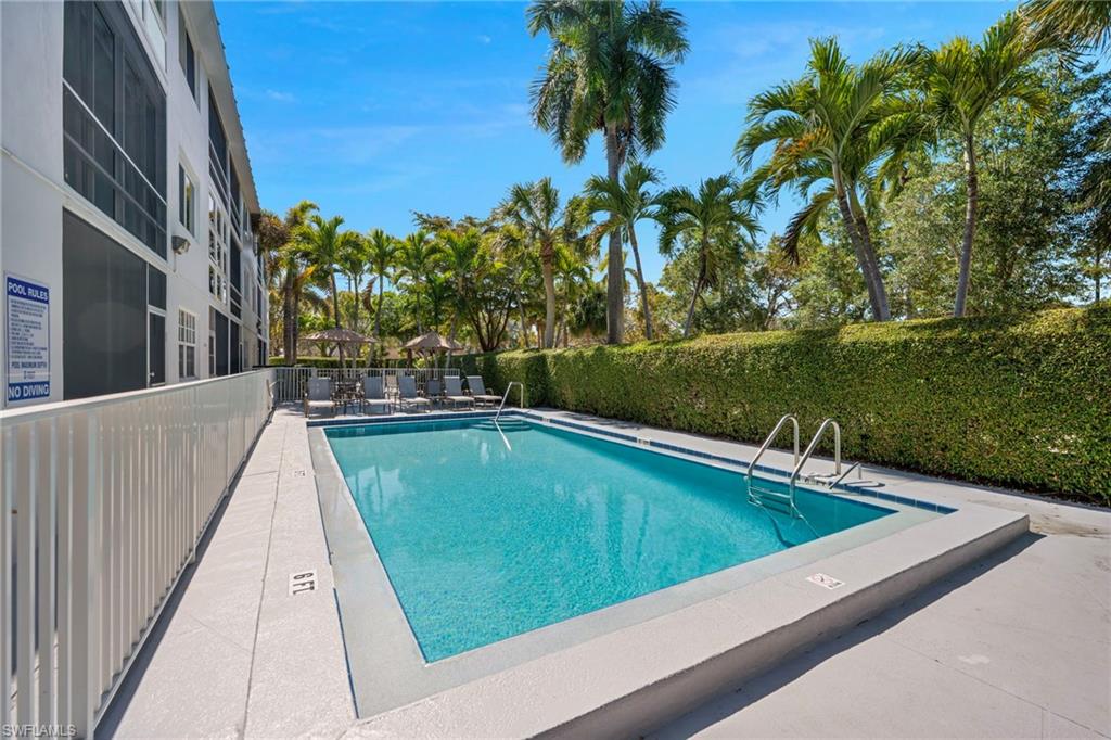 72 7th Street South, Unit 108 Naples, FL 34102 - Photo 8 of 22 a view of swimming pool with a yard