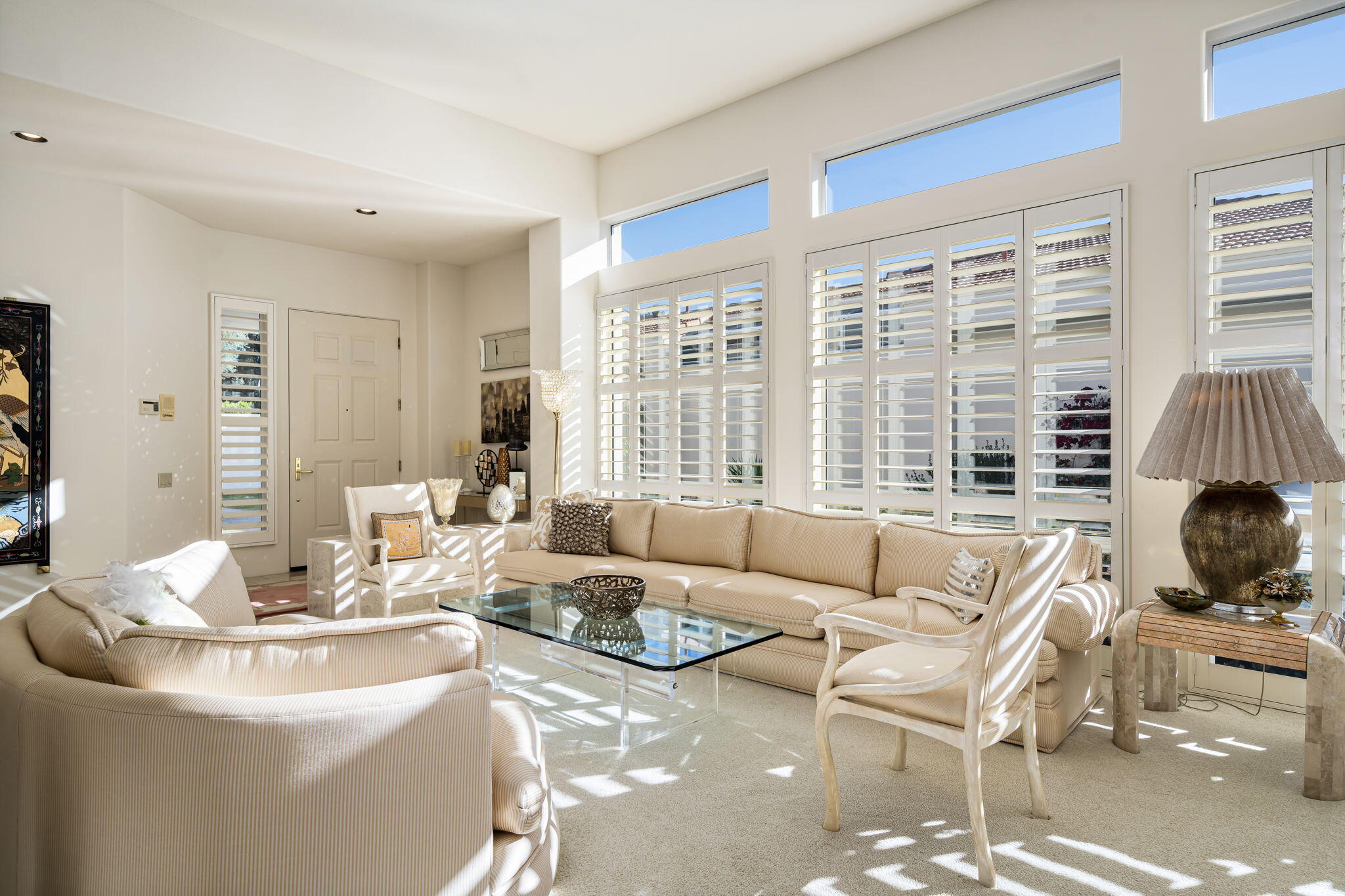 75315 St Andrews Court Indian Wells, CA 92210 - Photo 14 of 48 a living room with furniture and floor to ceiling windows
