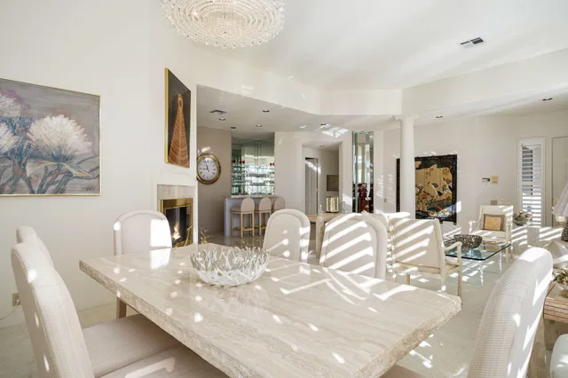 a view of a dining room with furniture and a large mirror