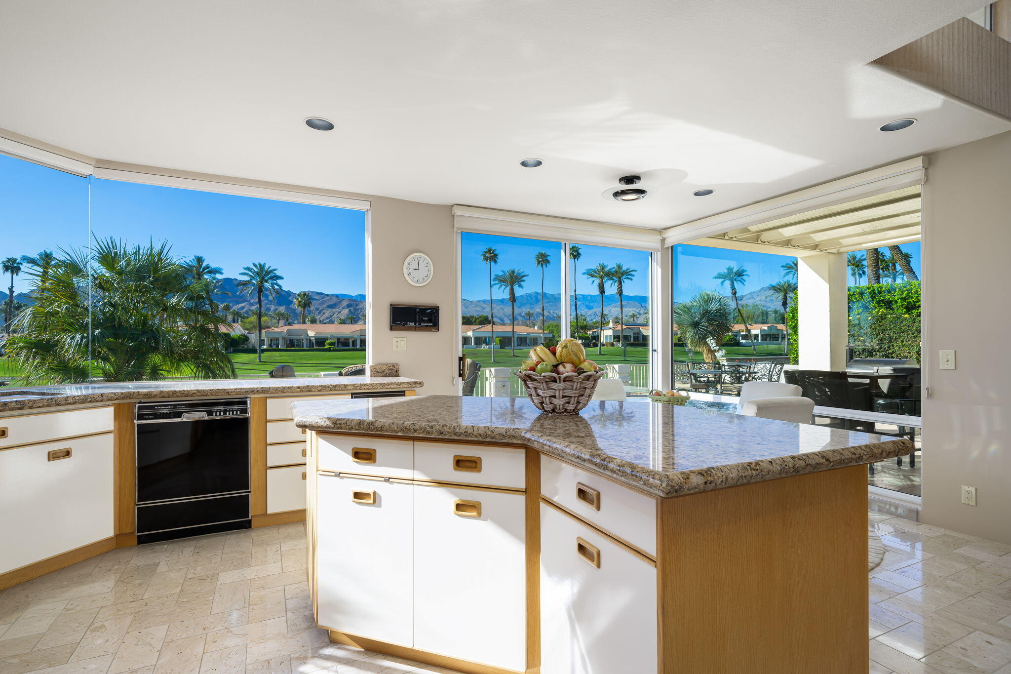 75315 St Andrews Court Indian Wells, CA 92210 - Photo 22 of 48 a kitchen with kitchen island granite countertop white cabinets and stainless steel appliances