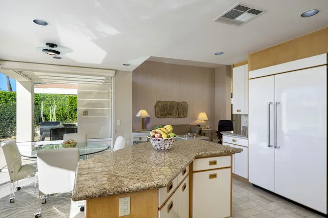 a kitchen with stainless steel appliances granite countertop sink refrigerator and microwave