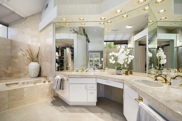 a bathroom with a granite countertop sink mirror and