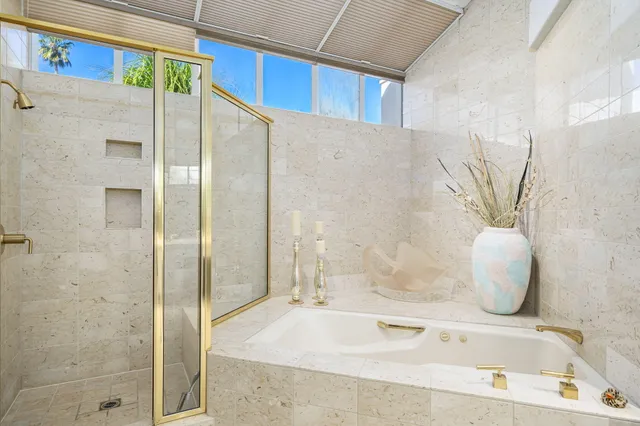 a bathroom with a tub and a shower