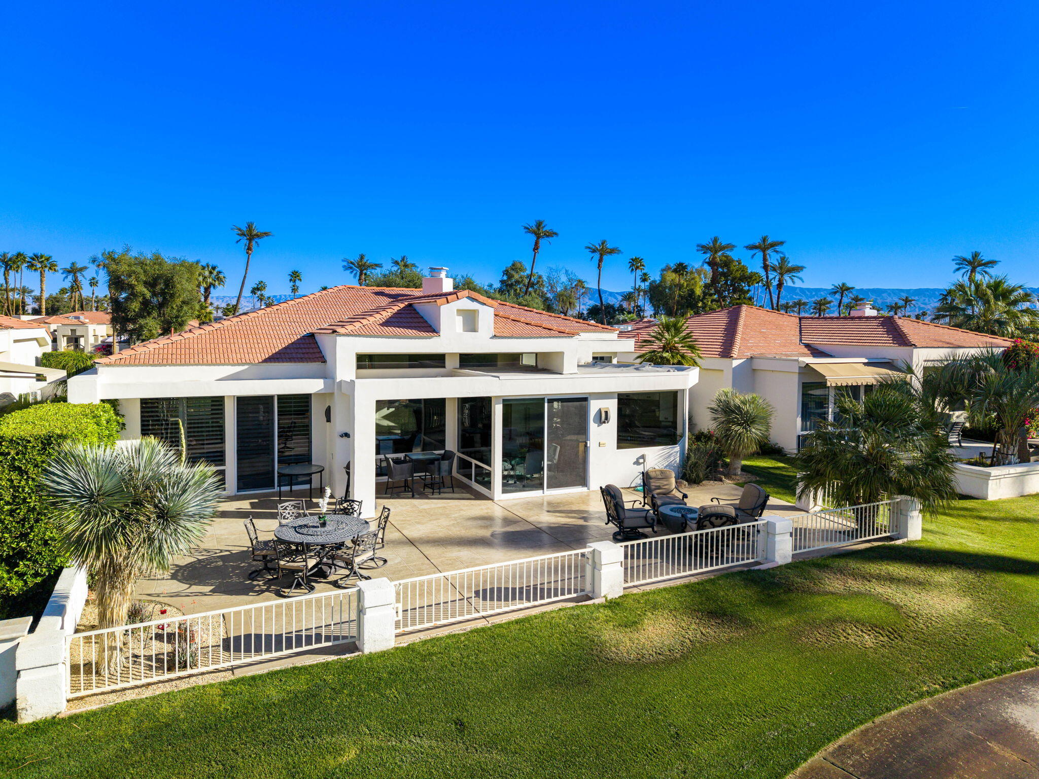 75315 St Andrews Court Indian Wells, CA 92210 - Photo 38 of 48 a view of a house with swimming pool and sitting area