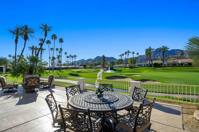 a view of a swimming pool and outdoor seating