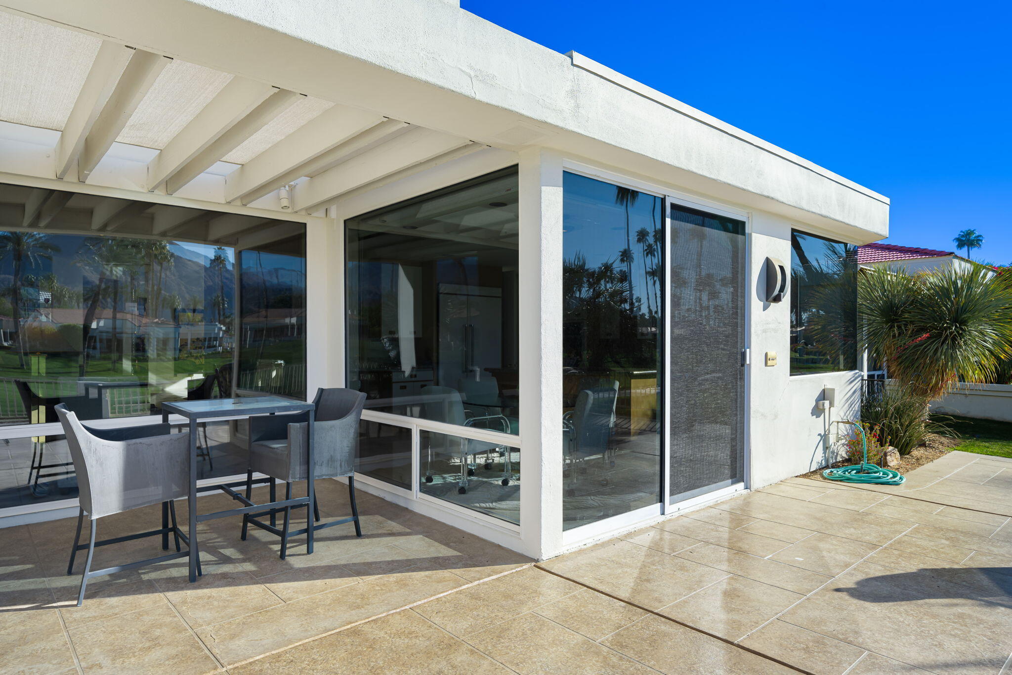 75315 St Andrews Court Indian Wells, CA 92210 - Photo 42 of 48 a view of a porch with table and chairs and potted plants