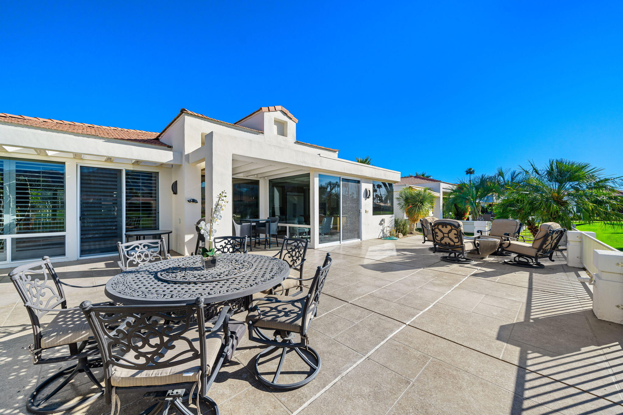 75315 St Andrews Court Indian Wells, CA 92210 - Photo 43 of 48 a view of a patio with table and chairs and potted plants