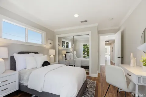 a bedroom with a bed and a chair
