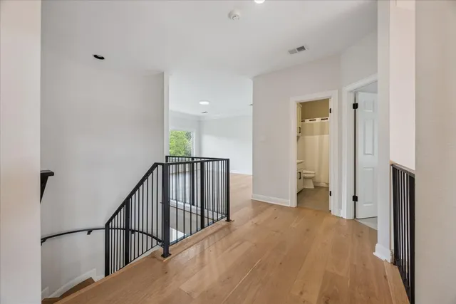 a view of a hallway with wooden floor and entryway