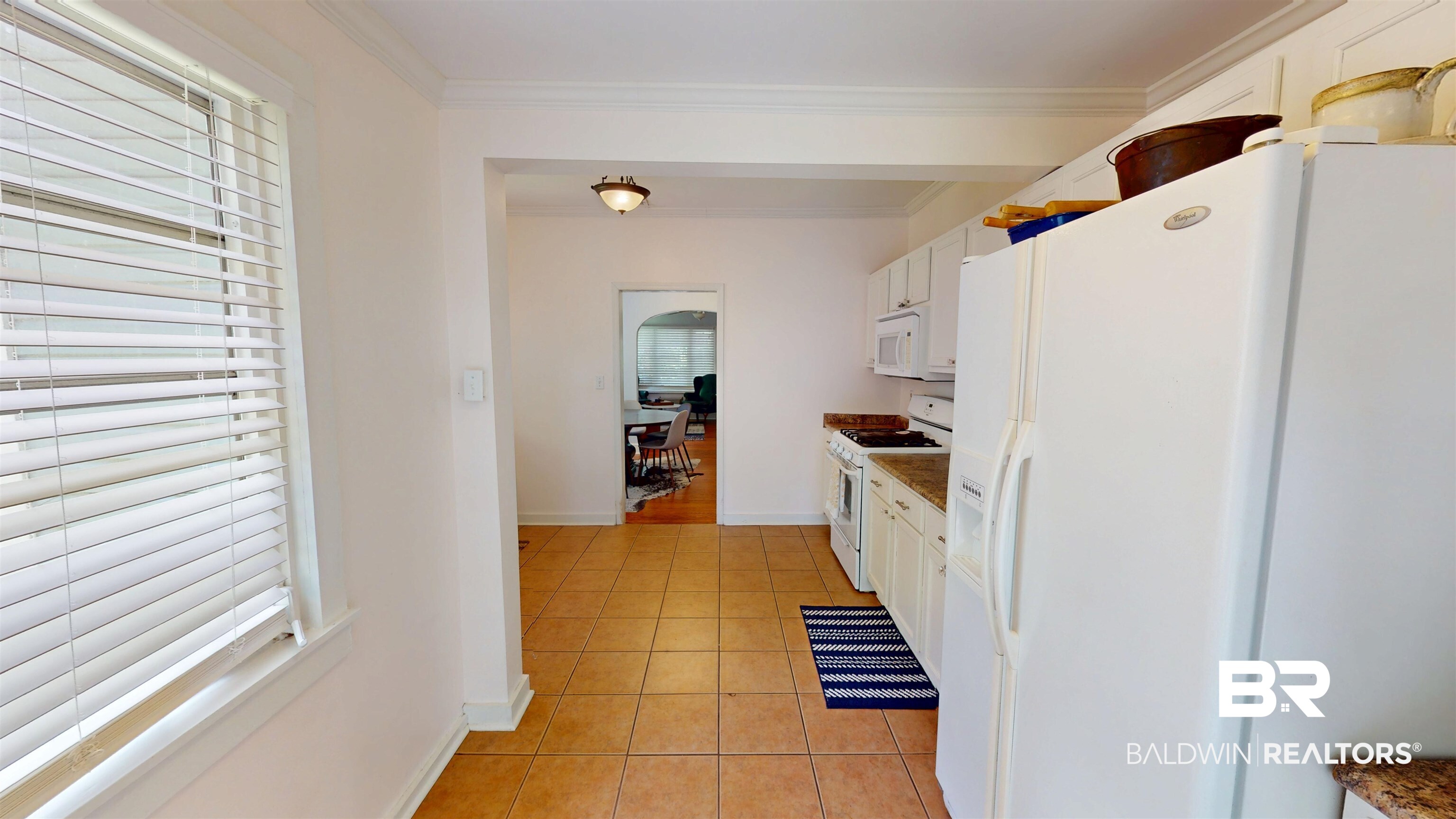 266 Westwood Street Mobile, AL 36606 - Photo 15 of 34 Kitchen featuring white appliances, white cabinets, light tile patterned floors, baseboards, and ornamental molding