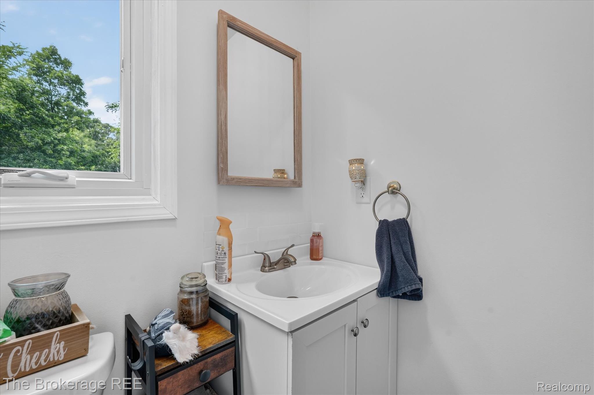 13269 North Genesee Road Clio, MI 48420 - Photo 32 of 67 White vanity with a single basin sink and brushed nickel faucet