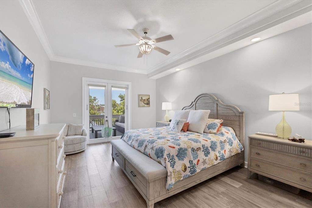 71 North Gulf Boulevard Placida, FL 33946 - Photo 25 of 52 a bedroom with a bed and a chandelier