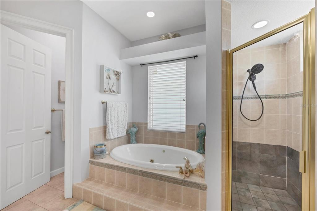 71 North Gulf Boulevard Placida, FL 33946 - Photo 28 of 52 a bathroom with a tub and a shower