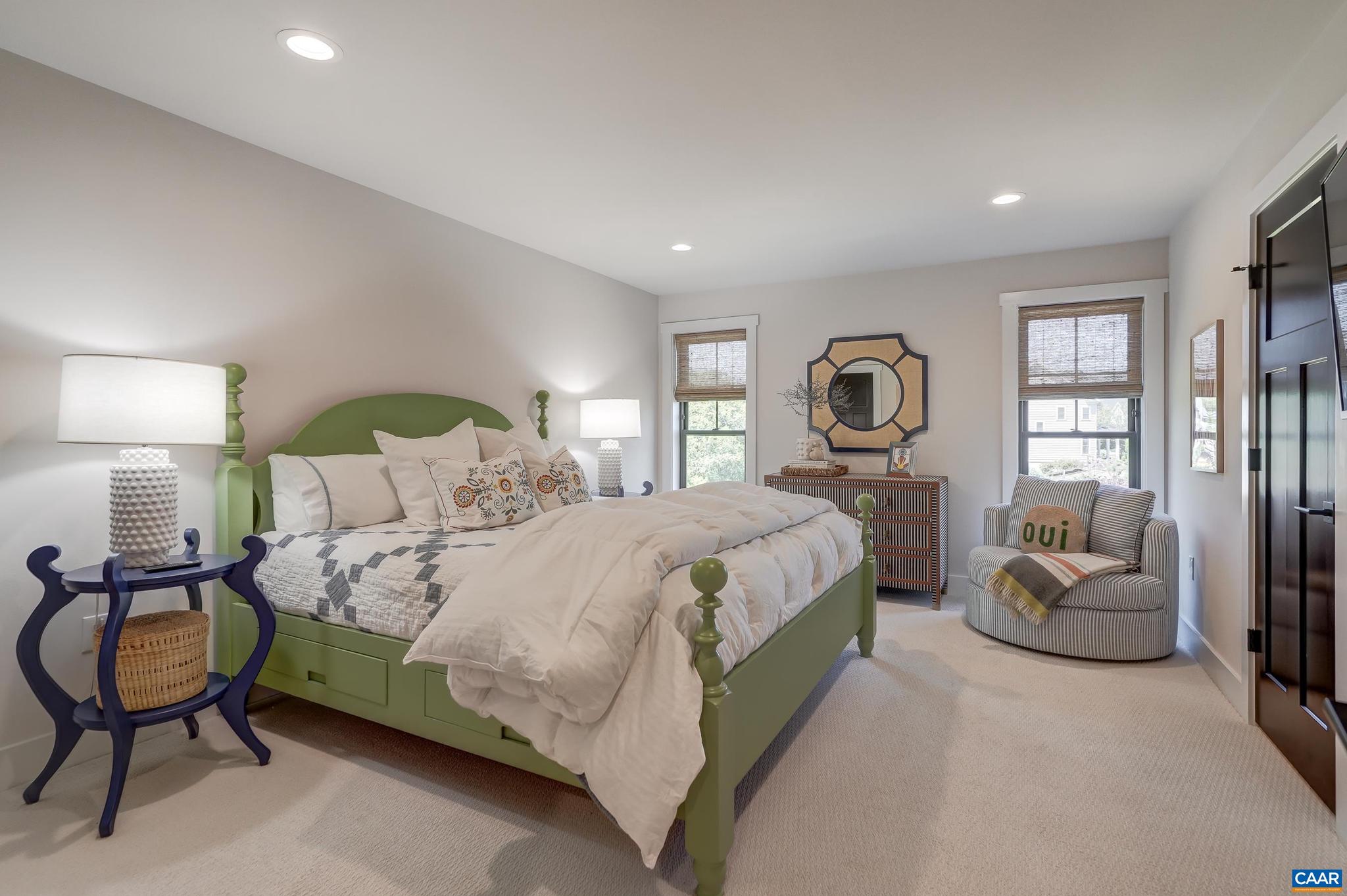 3327 Rowcross Street Crozet, VA 22932 - Photo 38 of 63 a spacious bedroom with a bed a couch and dresser in it