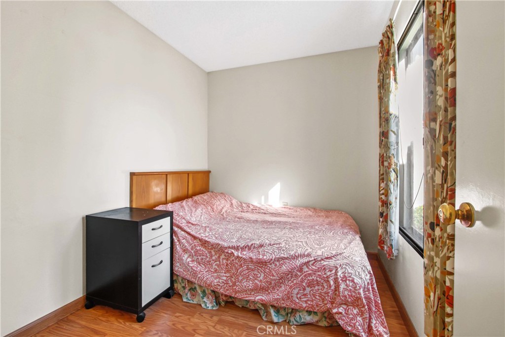 4501 Peck Road, Unit 23 El Monte, CA 91732 - Photo 8 of 12 a bedroom with a bed and wooden floor