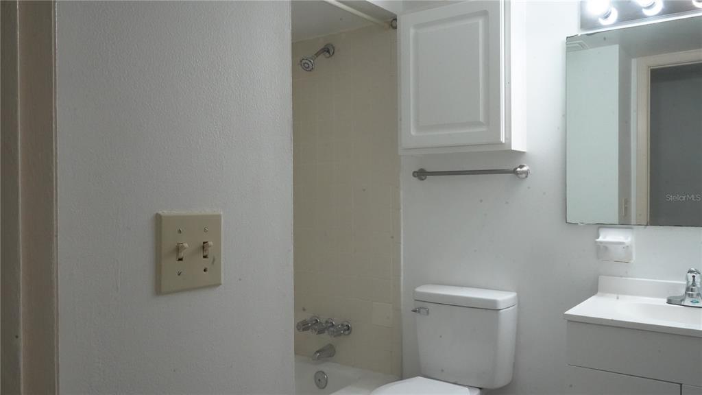 1700 Southwest 16th Court, Unit J4 Gainesville, FL 32608 - Photo 12 of 21 a bathroom with a sink a toilet and a mirror