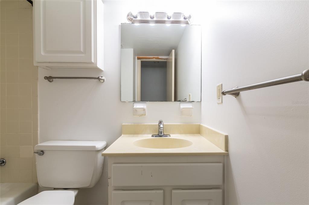1700 Southwest 16th Court, Unit J4 Gainesville, FL 32608 - Photo 9 of 21 a bathroom with a sink a toilet and mirror