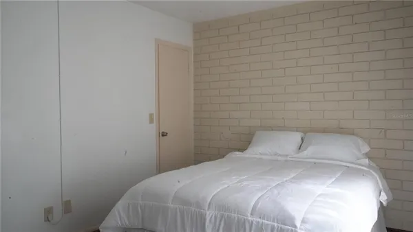 a bedroom with a bed and a mirror