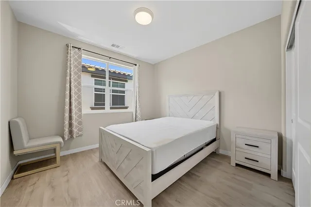 a bedroom with a bed and a chair