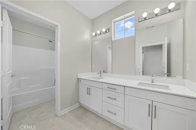 a bathroom with double sink and a mirror