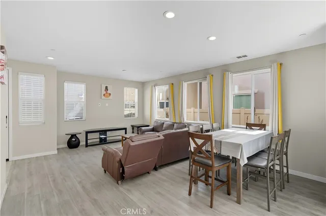 a living room with furniture and large windows