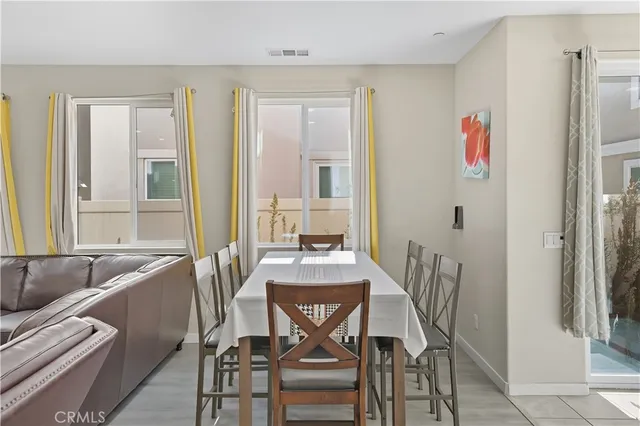 a view of a dining room with furniture a chandelier and wooden floor